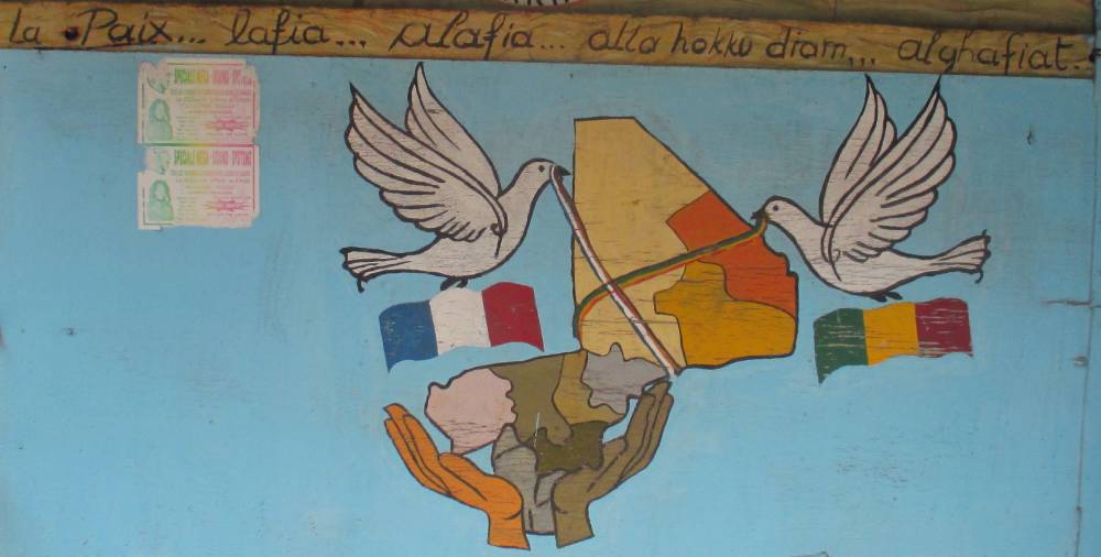 Local painting of peace doves over map of Mali