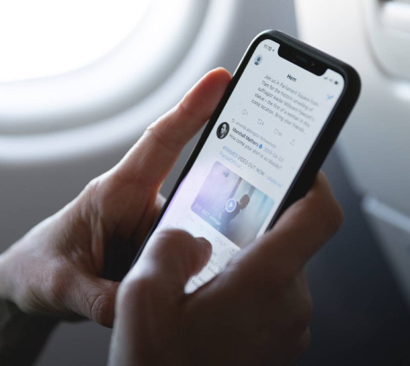 A user scrolls through a smart phone social media app